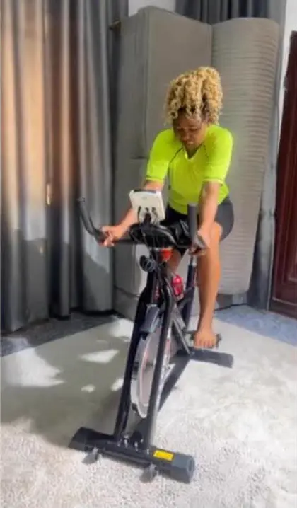 Customer riding the spinning bike at home
